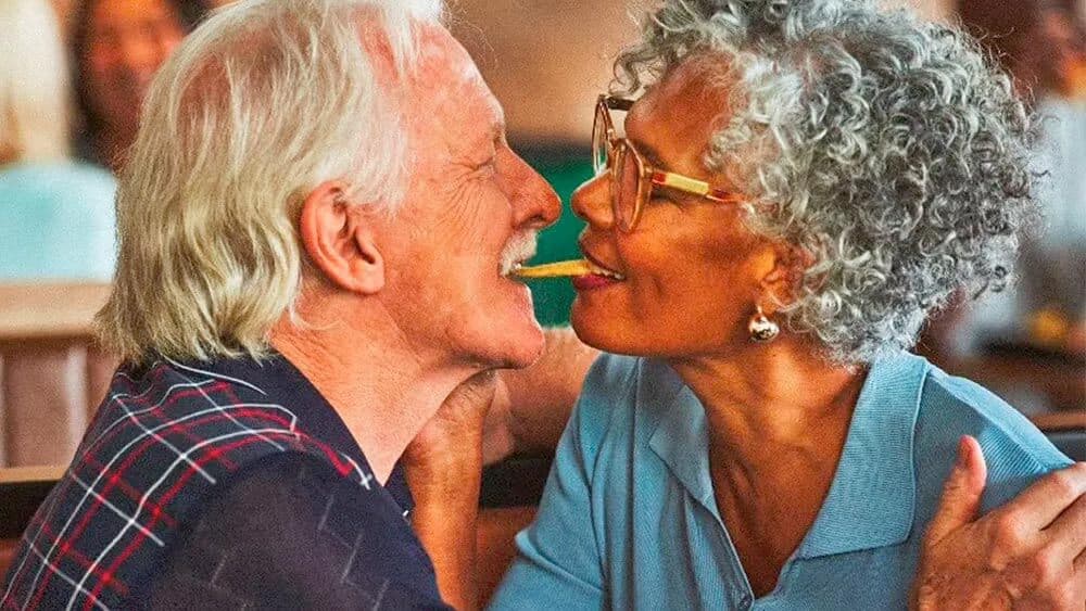 An older couple sharing a single fry between them in a Burger King advertisement